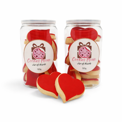 Two jars of heart shaped cookies with fondant icing with 2 cookies shown in front